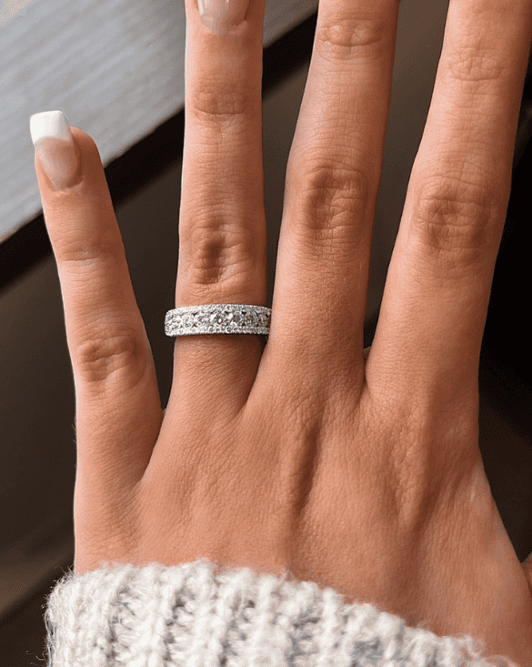 A person shows off a shiny diamond ring from Winter Jewelry, making the hand look stylish and special.