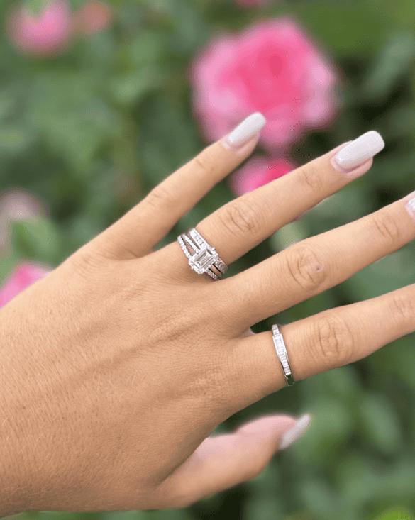 Winter Jewelry engagement rings on a hand, showing elegance and style, with a peaceful floral background.