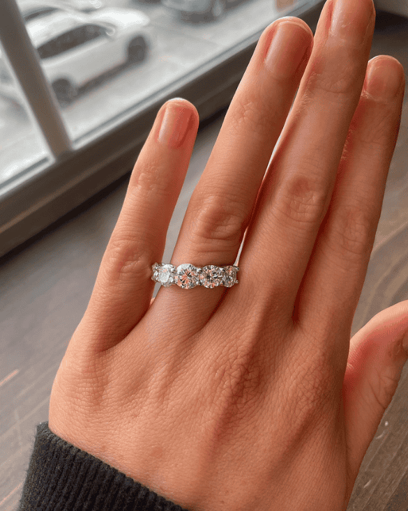 Winter Jewelry custom silver ring with five stones shown on a hand, conveying elegance and unique craftsmanship.