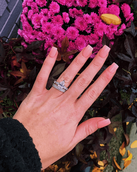 Winter Jewelry shows a hand with a gold diamond ring, giving pretty and fresh inspiration for engagement styles.