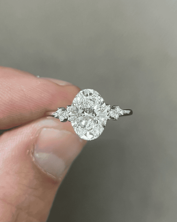 A hand displays a Winter Jewelry ring, highlighting its bright diamonds and showing the look of their diamond jewelry style.