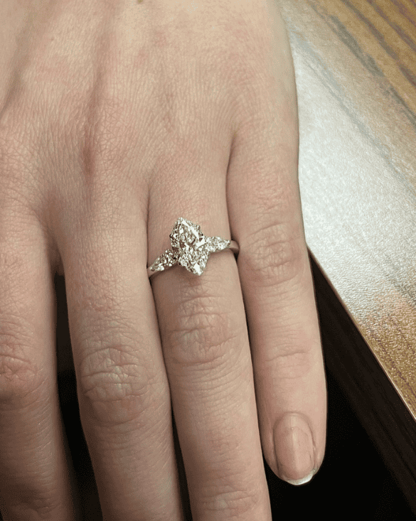 A person proudly shows an elegant diamond ring from Winter Jewelry, highlighting its beauty and special meaning.