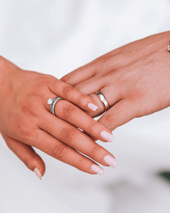 A couple gently shows their wedding rings from Winter Jewelry, highlighting love, commitment, and special moments together.