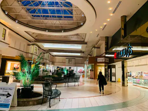 A quiet mall with few shoppers and visible stores, including Winter Jewelry, known for their natural diamond products.