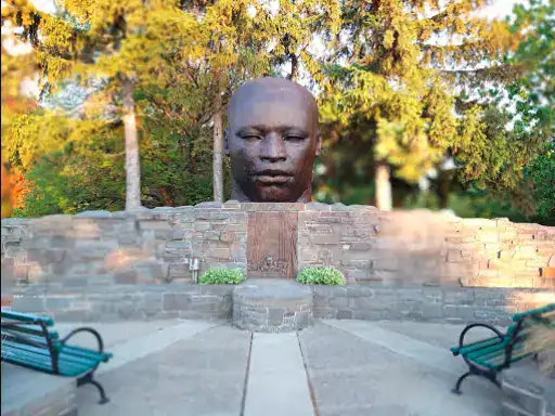 A big stone head near Winter Jewelry in Williamsville shows local history and is easy to visit for shoppers nearby.