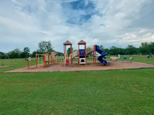 The playground feels joyful and welcoming, reflecting the happy spirit of Winter Jewelry in a bright, open park setting.