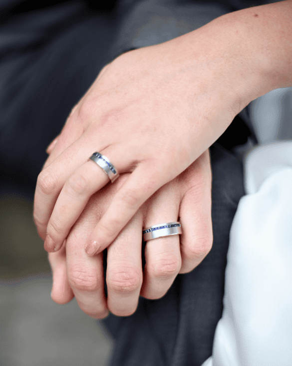 A couple shows off matching Winter Jewelry rings, symbolizing love and commitment with a simple, elegant style.